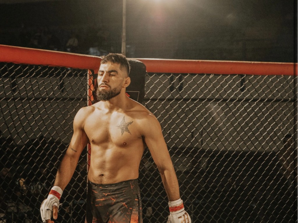 Dadmehrrr MMA fighter under arena lights Trojan Fight Club Cyprus